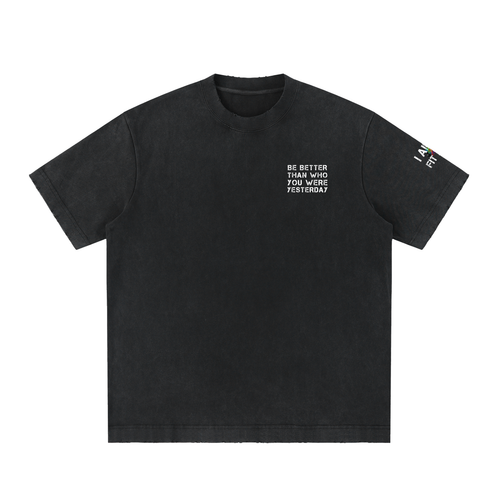 A black short-sleeve crewneck t-shirt with white printed text on the left chest reading 'BE BETTER TOMORROW YOU WERE YESTERDAY' and a small white graphic on the right sleeve, shown on a plain white background.