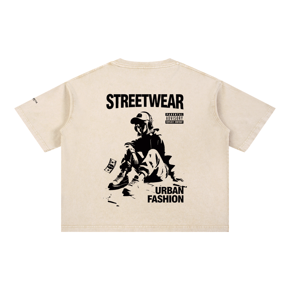 A cream-colored short-sleeve t-shirt shown from the back, featuring a large black graphic print of a person sitting with the text 'STREETWEAR' and 'URBAN FASHION' on a plain white background.