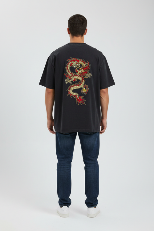 Person wearing a black t-shirt with a colorful dragon design on the back, standing against a white background.