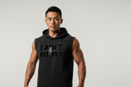 Man wearing a black sleeveless hoodie with text on a plain background