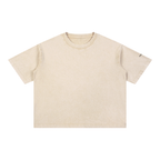 A short-sleeve crewneck t-shirt in a washed, light beige color, shown flat against a solid white background.